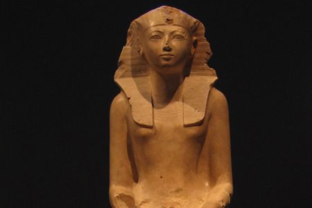 Hatshepsut is depicted in the clothing of a male king though with a feminine form. Inscriptions on the statue call her "Lady of the Two Lands."