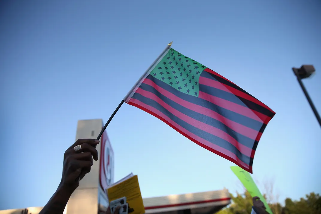 African American Flag, protest, Ferguson, 2014