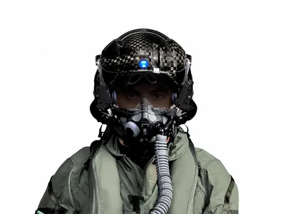 The F-35 helmet is an information-display device, showing targeting data, status of the aircraft systems, and visual and infrared views of the world outside the airplane. The blue circle on the helmet is its night-vision camera.