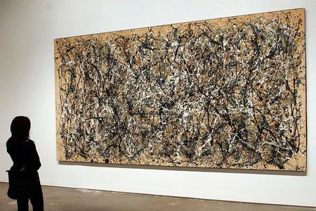A visitor to MoMA views Jackson Pollock's painting "One (Number 31, 1950)" 

