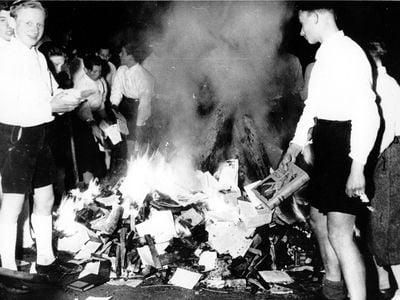 Hitler Youth members burn books. Photograph dated 1938.