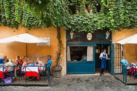 Diners eat lunch outdoors at the Osteria Margutta. 