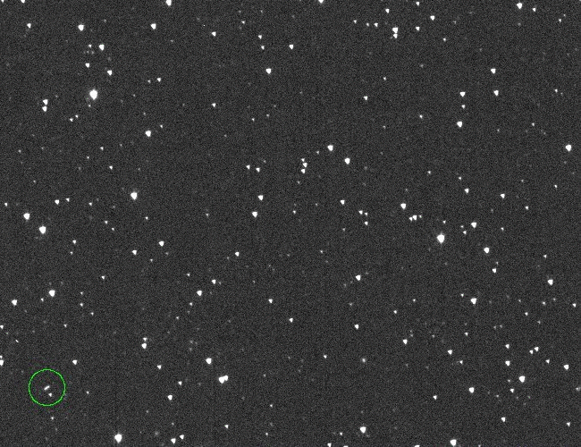 gif of an asteroid, appearing as a point of light flying across a backdrop of stars