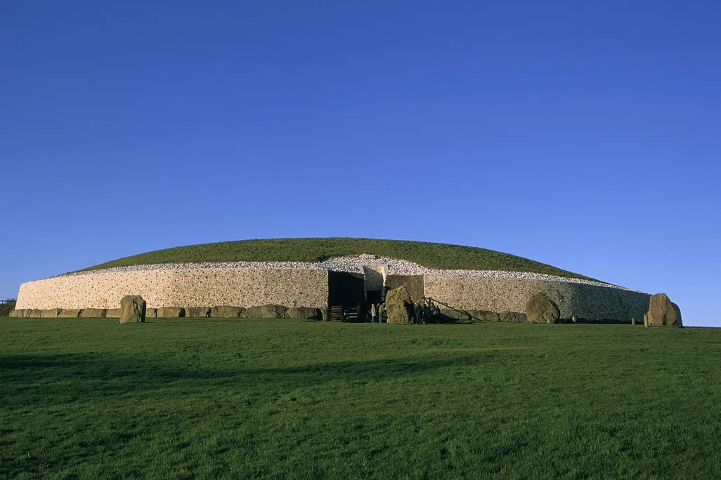 Mound of grass with a stone wall around it