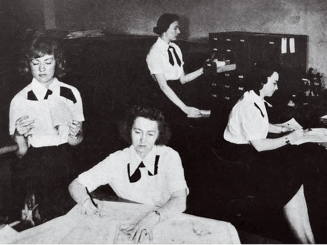 a group of woman naval officers in an office setting