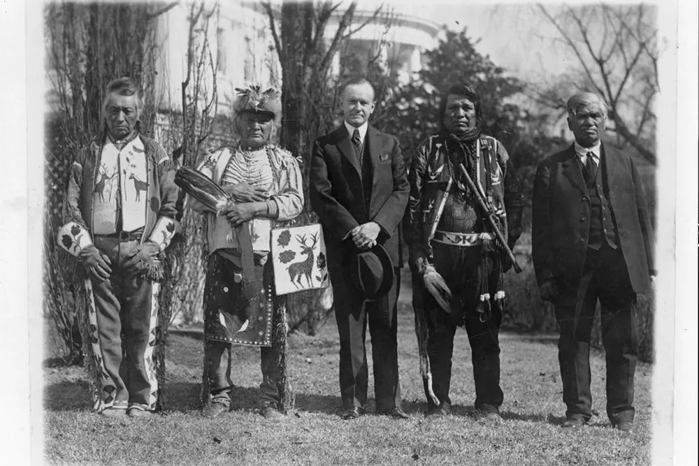 Calvin Coolidge poses with Native American leaders on the White House lawn in 1925