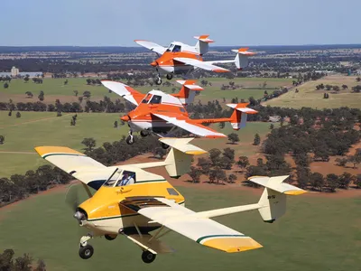 A rare three-ship formation of TransAvia PL-12 AirTruks led by Ian Bell (in yellow) with Nick Wills (center) and Steve Death (top) departs an October 2018 airshow in Temora, New South Wales, Australia. 

