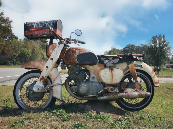 An old Honda motorcycle converted to a mailbox stand thumbnail