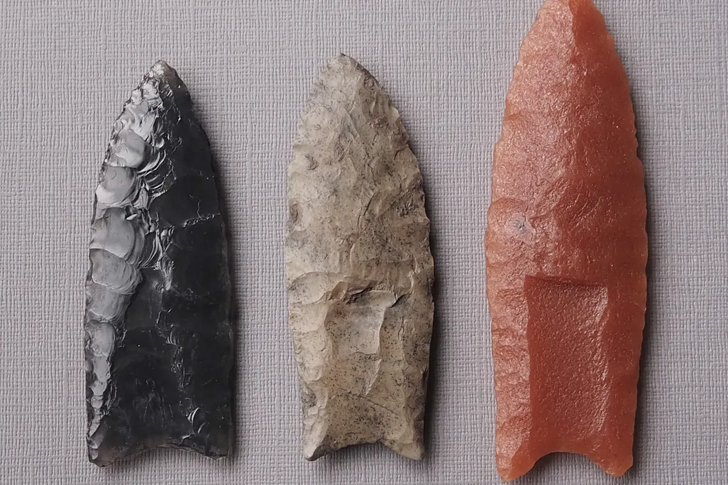 Overhead shot of three small pointed weapons made of rock