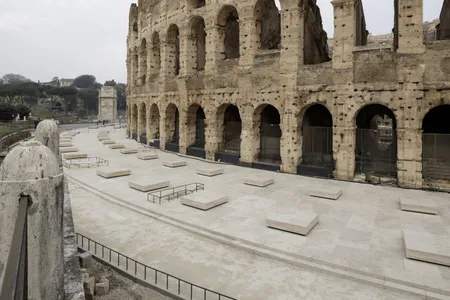 Outside the Colosseum's southern wall, newly constructed marble slabs indicate where tall columns once supported two arcades.