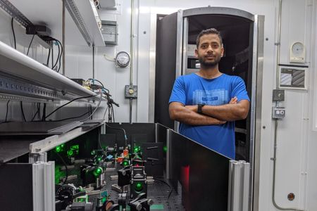 Physicist Avinash Kumar of Simon Fraser University stands beside the Mpemba effect apparatus.