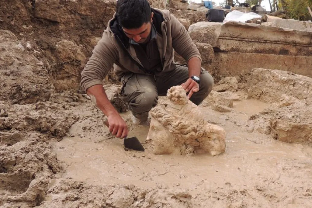 Worker excavating stone head of Aphrodite