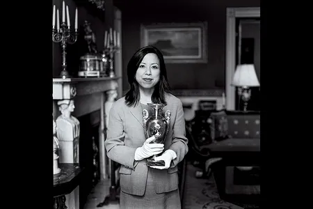 Donna Hayashi Smith, a curator, has been in charge of everything from borrowing famous paintings to handling a 19th-century menorah. Here, she holds a French porcelain vase from 1820.