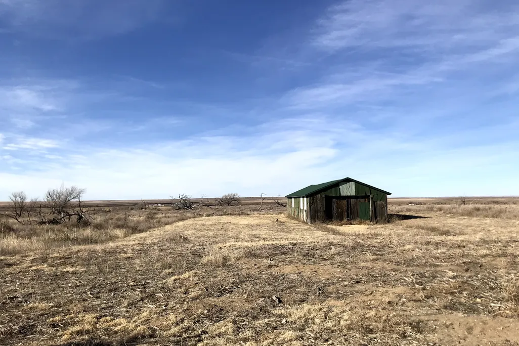 Old green building at the site of the former Granada Relocation Center in Colorado