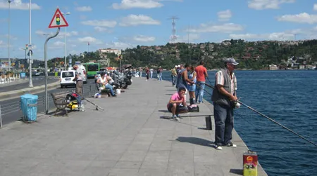 Fishermen pass the hours along the Bosporus Strait. They occasionally catch sardines.