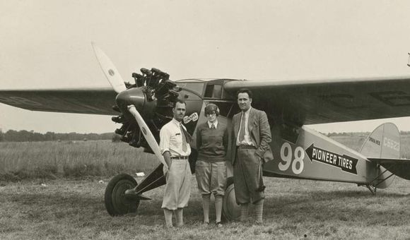 Three-quarter left front view of Cessna BW-5 (r/n C6623, National Air Races race no. 98) on the ground, possibly at Roosevelt Field, Long Island, New York, circa September 1928. Posed standing beside nose of aircraft are pilot Francis D. 