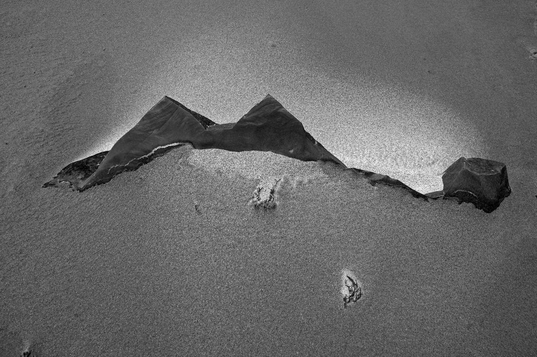 Rocks protruding from windswept beach in Spain's Atlantic coast ...