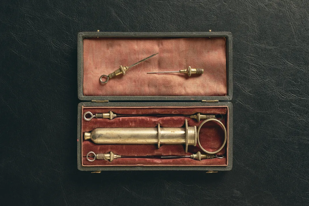 Items from Mass General’s collections include a 19th-century syringe and needles.