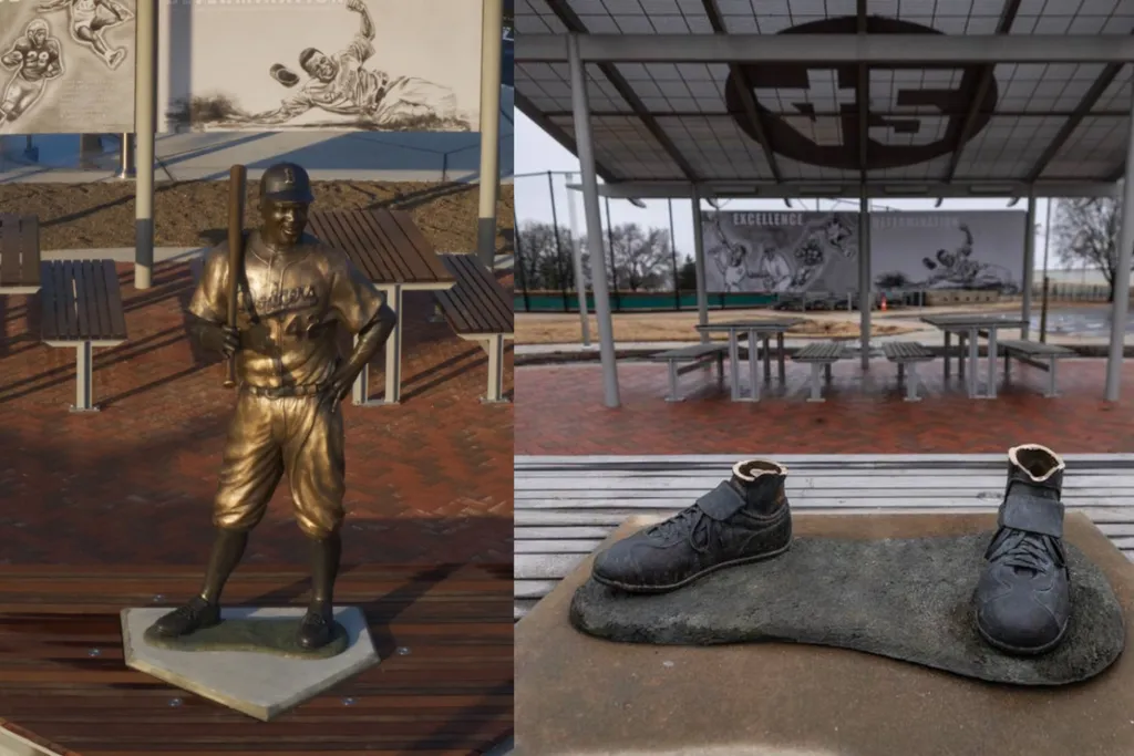 Side by side of a bronze statue of Jackie Robinson and a pair of bronze statue feet