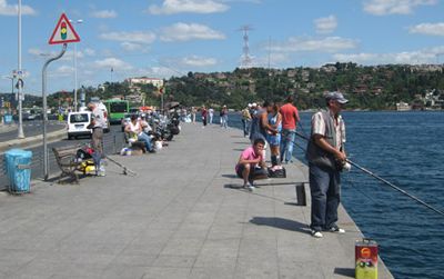 Fishermen pass the hours along the Bosporus Strait. They occasionally catch sardines.