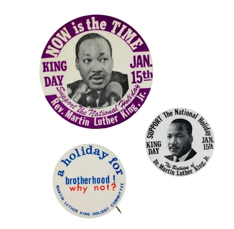 Three buttons supporting the supporting the creation of a federal holiday in honor of Dr. Martin Luther King, Jr.