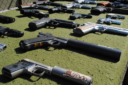 Pistols equipped with silencers, confiscated from drug dealers. 
