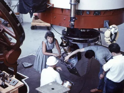 Vera Rubin works with a telescope at Lowell Observatory in Arizona in 1965. 