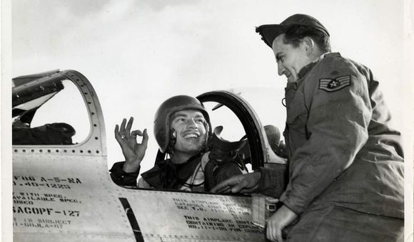 Lt. Ward Hitt, Jr., sitting in the cockpit of his North American F-86A Sabre fighter, gives his crew chief the OK hand sign, South Korea.