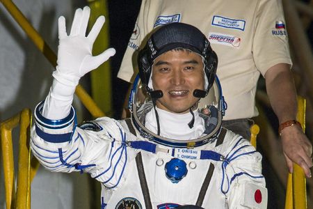 Takuya Onishi yesterday, about to board his Soyuz MS-01 spacecraft.
