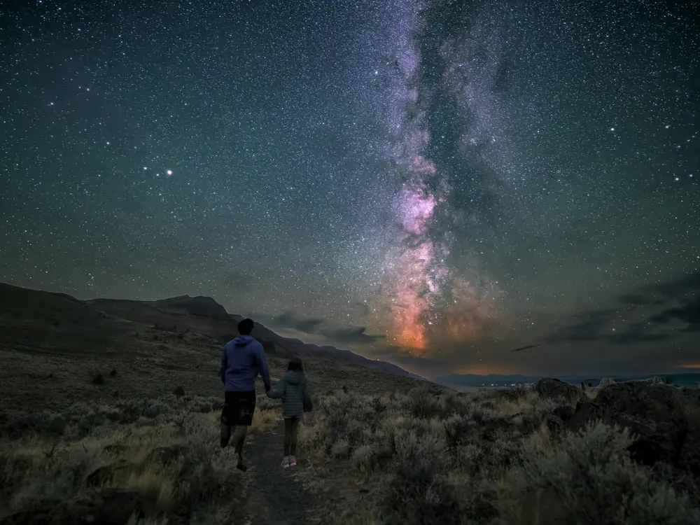 Milky Way above two people