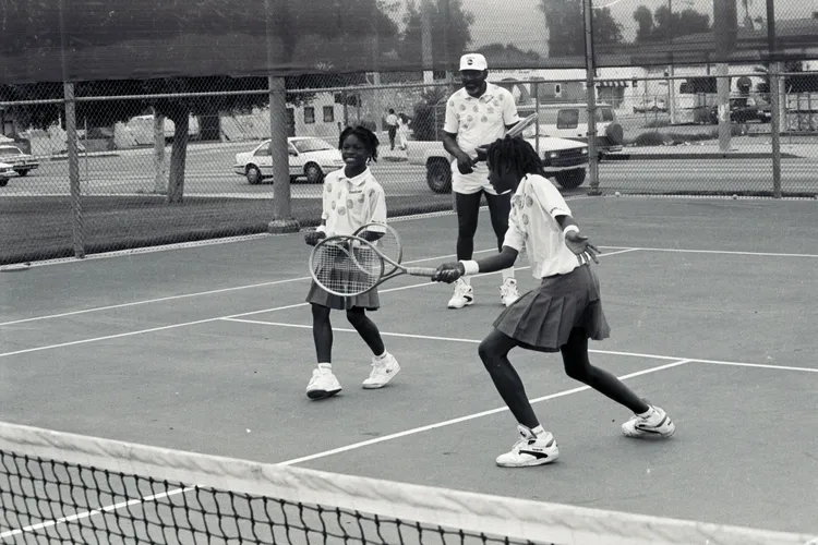 Serena, Venus and their father on the tennis court
