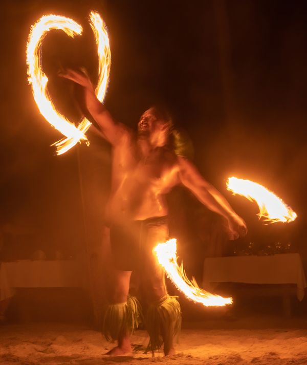 On a small island off Huahine, a fire dancer shows off his skill thumbnail