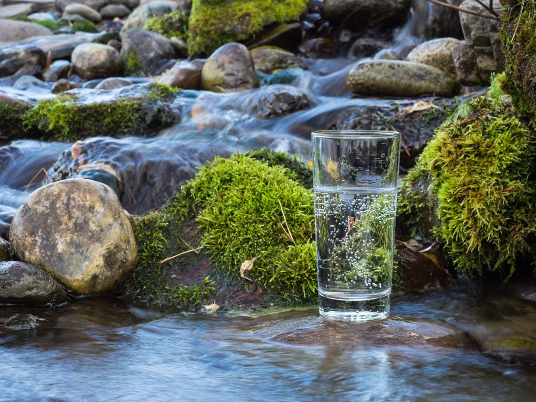 Image of glass of water by a stream