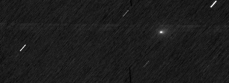 white streaks and a single fuzzy white dot across space