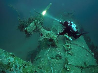 Diver Chris de Putron inspects the wreck of the German submarine UC-18, which sank off the Channel Islands in February 1917.