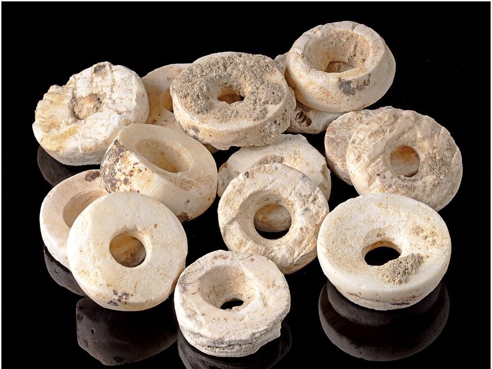 Disc-shaped white beads against a black background