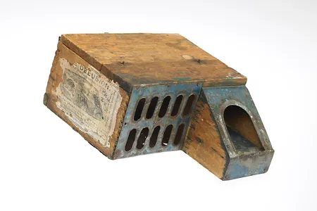 An 1877 mousetrap called “The Delusion.” Directions read “Put as large a piece of cheese you can crowd into the box…”
