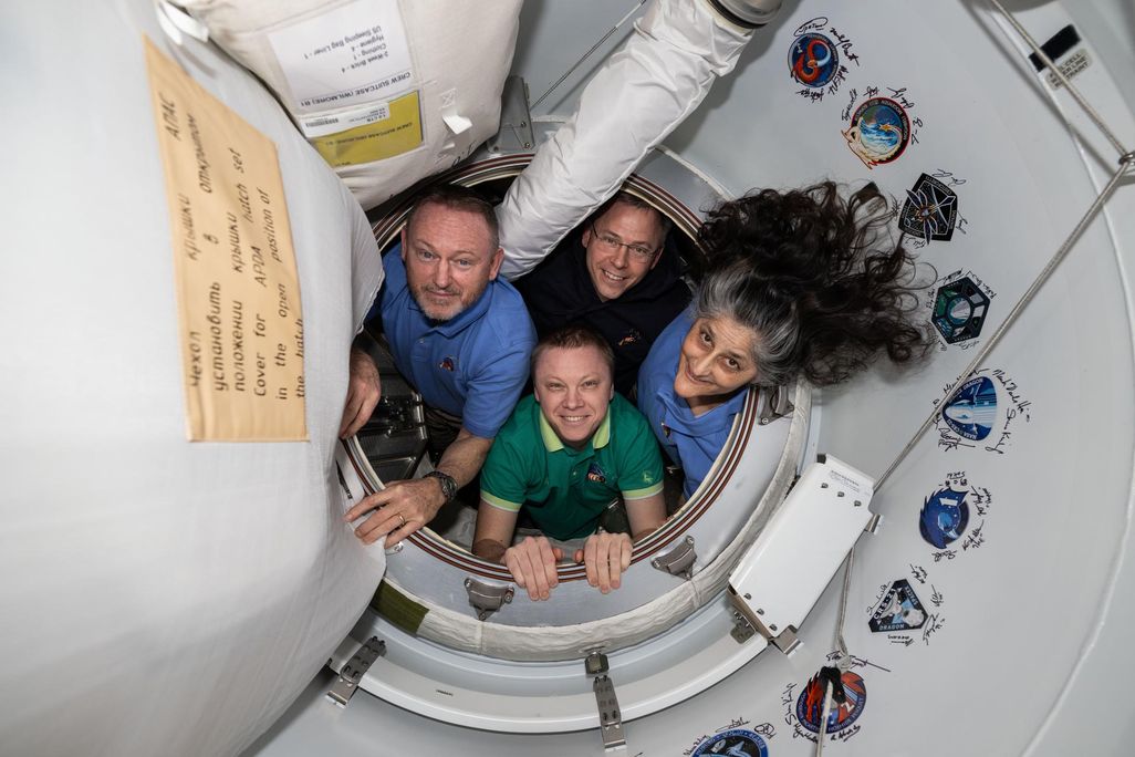 Four astronauts posing for a photo