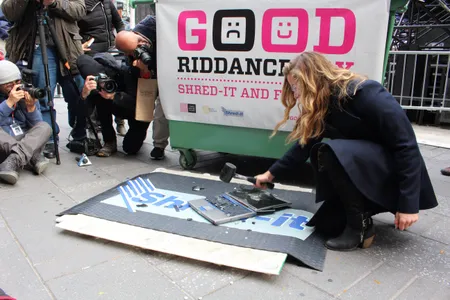 A woman smashes her laptop at Good Riddance Day in 2015