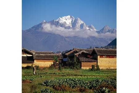 The highest summit of the Jade Dragon (Yulong Xueshan) from what in 1985 was close to the center of the old town of Lijiang, China.