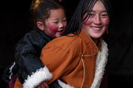 Rosy cheeks and warm garments are reasons to smile for this mother-daughter duo.

