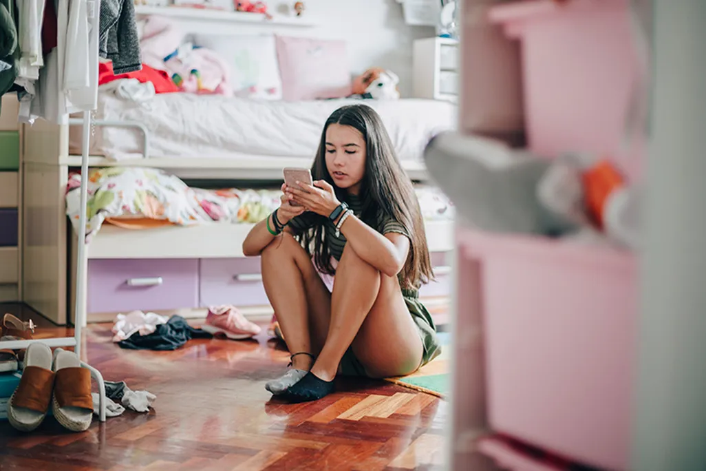 Teen girl on her mobile device-main.jpg