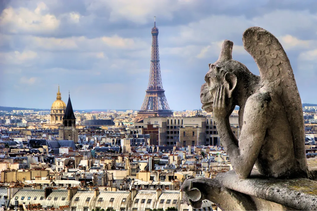 Gargoyle from Notre Dame looking out over Paris