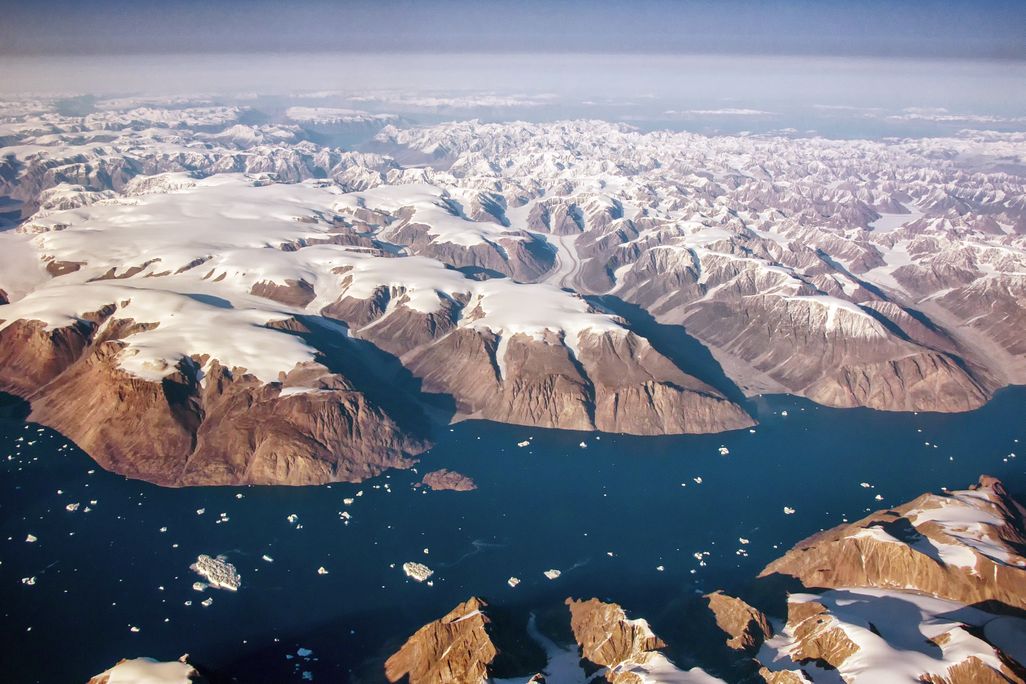 An aerial view of Greenland's snowy fjords, glaciers and mountains