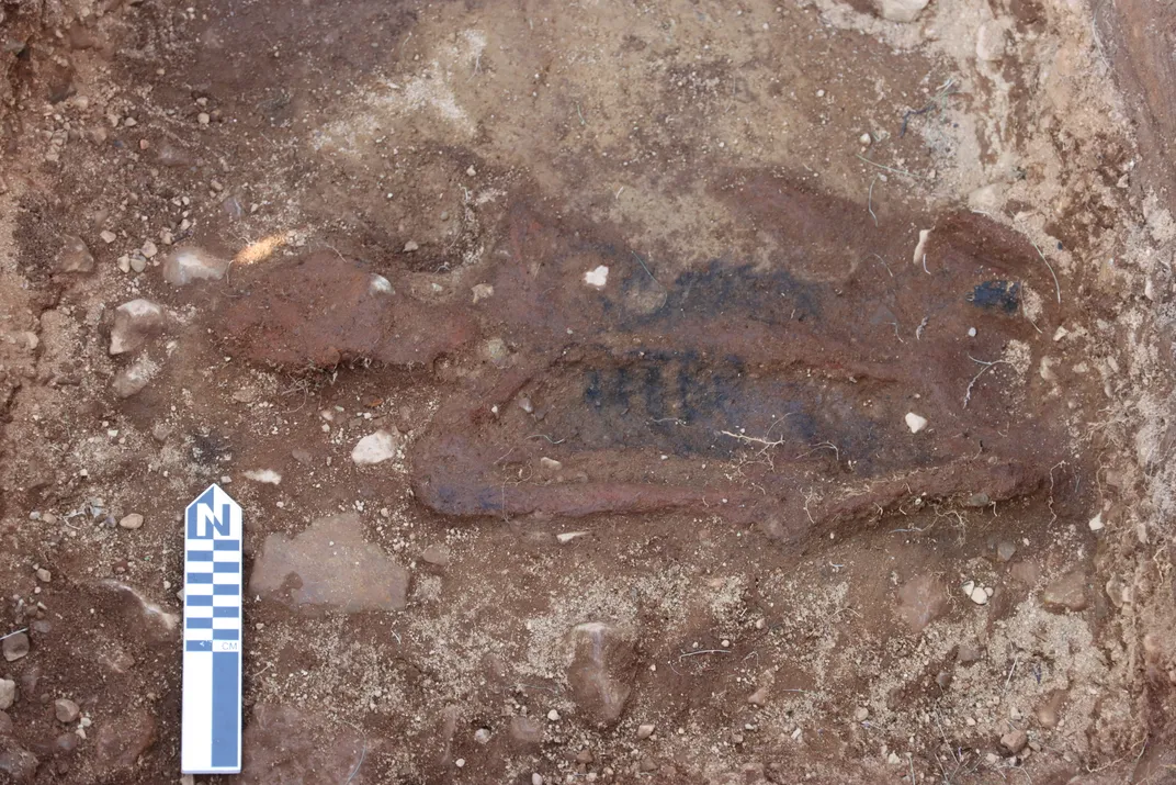 The outline of a human skeleton in dirt