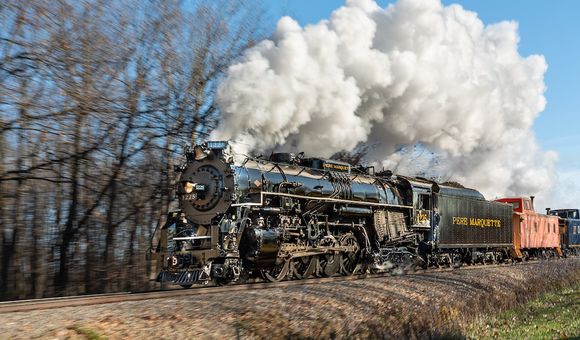 A steam locomotive with smoke billowing