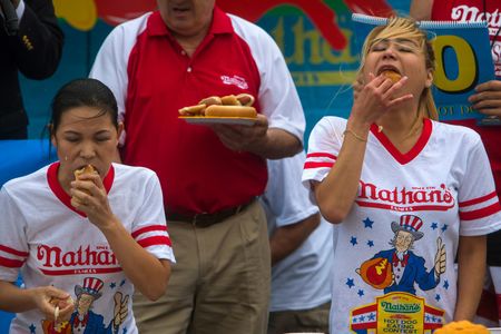 Miki Sudo takes on the 2013 women's champ Sonya Thomas. Sudo would grab Thomas' title by consuming 34 hot dogs to Thomas' 27.75. 