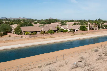 The CAP canal is pictured running past houses and businesses it feeds in Scottsdale, Ariz. The Central Arizona Project is a 336-mile, man-made river of canals that delivers water from the Colorado River basin uphill to service water needs in southern Arizona, including Tucson and Phoenix.