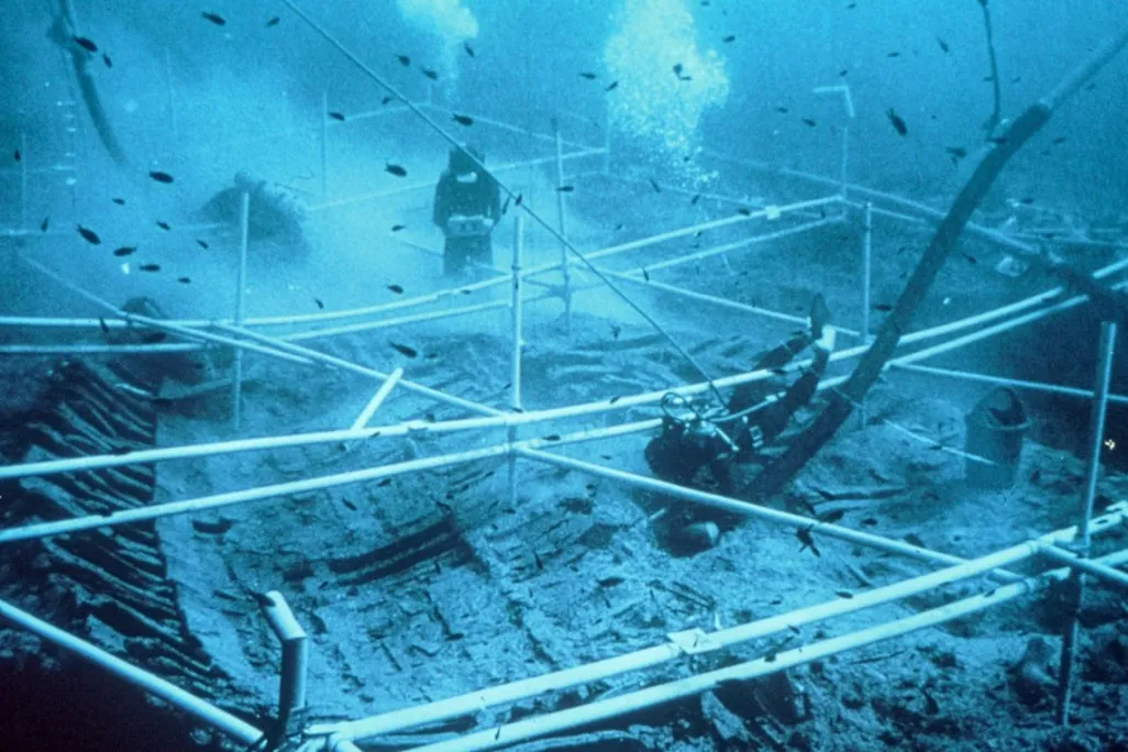 Underwater image of divers exploring a shipwreck