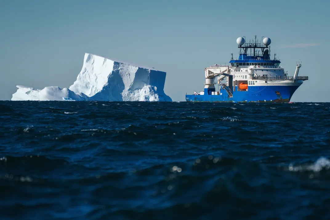 Research vessel near iceberg